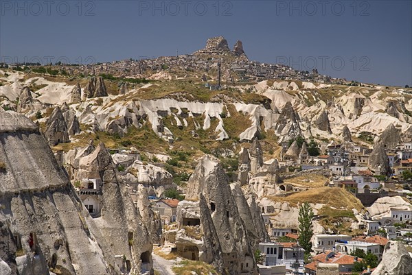 Cave hotel in foreground with view across volcanic tufa landscape towards hilltop town of Uchisar. Photo : Hugh Rooney