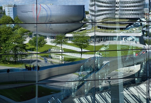 BMW Headquarters and museum reflected in glass facade of BMW Welt showroom creating distorted image. Photo : Hugh Rooney