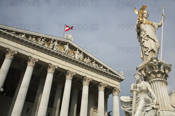 Statue of Athena raised on pillar above fountain in front of the Parliament building colonnaded facade. Photo : Bennett Dean