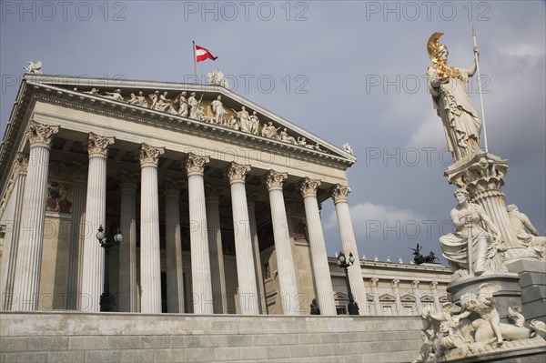 Statue of Athena raised on pillar above fountain in front of the Parliament building colonnaded facade. Photo: Bennett Dean