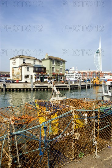 The Camber in Old Portsmouth showing the Spinnaker Tower behind the Bridge Tavern with its mural of Thomas Rowlansons cartoon titled Portsmouth Point and fishing boats moored along the quayside. Photo : Paul Seheult