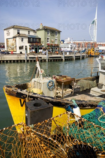 The Camber in Old Portsmouth showing the Spinnaker Tower behind the Bridge Tavern with its mural of Thomas Rowlansons cartoon titled Portsmouth Point and fishing boats moored along the quayside. Photo: Paul Seheult