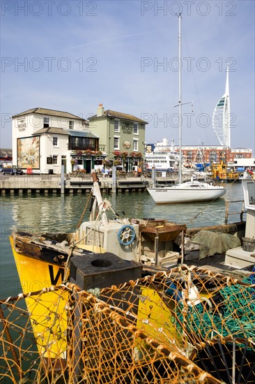 The Camber in Old Portsmouth showing the Spinnaker Tower behind the Bridge Tavern with its mural of Thomas Rowlansons cartoon titled Portsmouth Point and fishing boats moored along the quayside. Photo : Paul Seheult