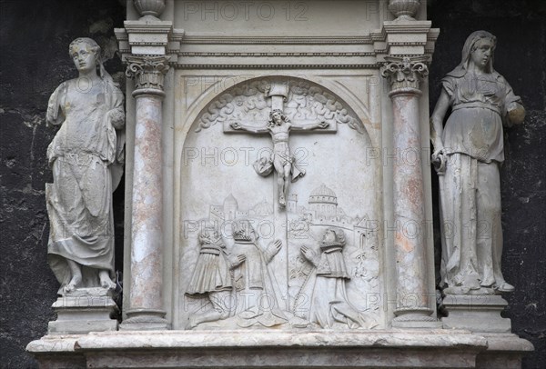 Stone relief carving of the crucifixion flanked by statues on the outside of the Stephansdom Cathedral. Photo : Bennett Dean