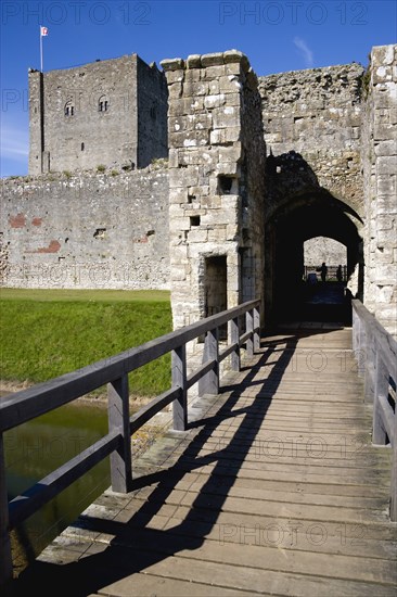 Portchester Castle showing the Norman 12th Century Tower and 14th Century Keep beyond the bridge over the moat built within the Roman 3rd Century Saxon Shore Fort. Photo : Paul Seheult