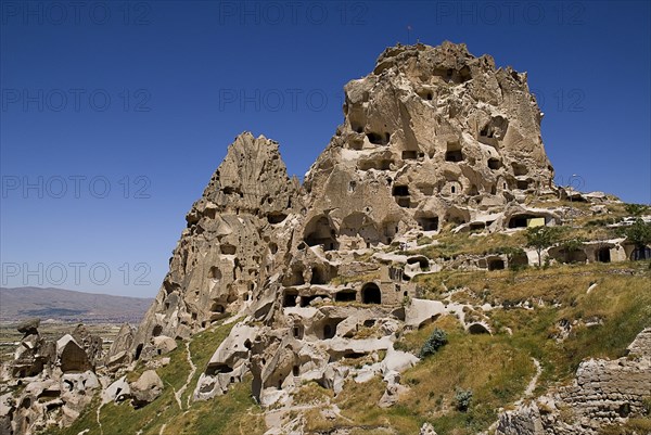 Uchisar Castle. Huge volcanic rock outcrop riddled with tunnels and dovecote windows. Photo : Hugh Rooney