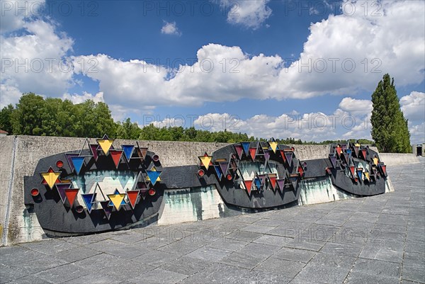 Dachau World War II Nazi Concentration Camp. Prisoner badges memorial Communists were given red triangles Jews yellow and foreign workers blue. Photo: Hugh Rooney