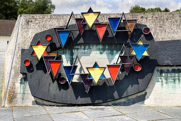 Dachau World War II Nazi Concentration Camp. Prisoner badges memorial Communists were given red triangles Jews yellow and foreign workers blue. Photo : Hugh Rooney
