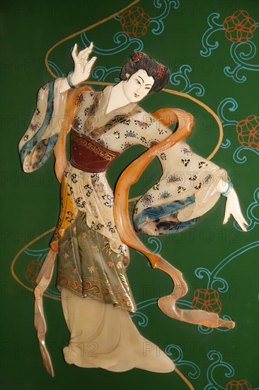 Painted jade carving of a Chinese woman on a piece of furniture. Photo : Mel Longhurst