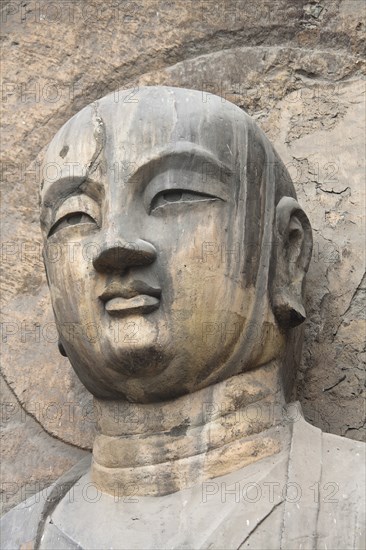 Carved Buddha statue in the Fengxian Temple Tang Dynasty Longmen Grottoes and Cave. Photo : Mel Longhurst