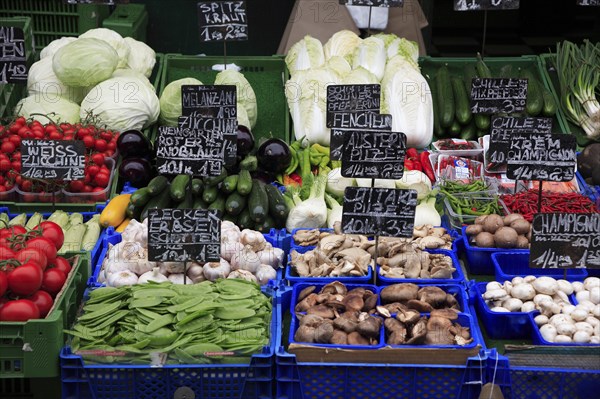 Vegetable stall in the Naschmarkt displaying produce including mushrooms tomatoes aubergine and courgettes. Photo: Bennett Dean