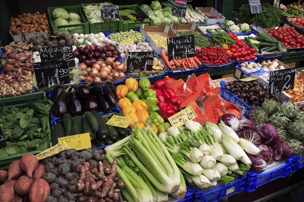 Vegetable stall in the Naschmarkt with display of produce including celery fennel aubergines and courgettes. Photo: Bennett Dean