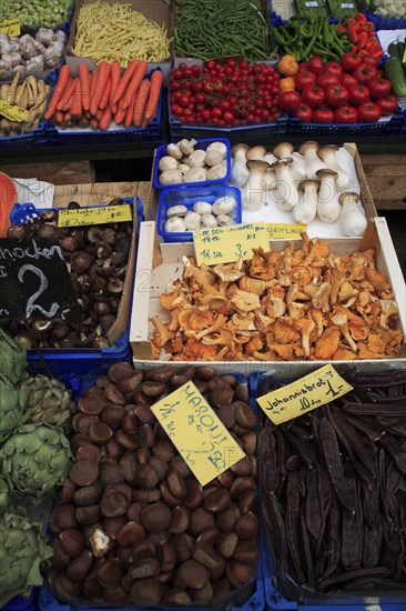 Vegetable stall in the Naschmarkt. Cropped view of display of produce including mushrooms hazelnuts and artichokes. Photo : Bennett Dean