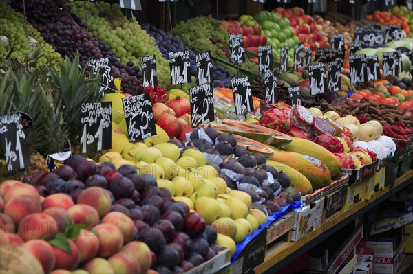 Fruit stall in the Naschmarkt with display of produce including peaches plums pears and figs. Photo : Bennett Dean