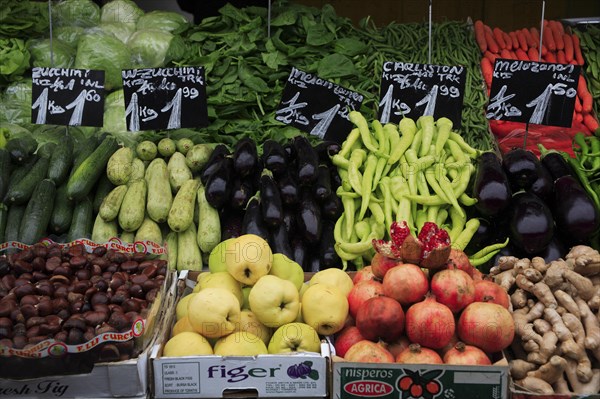 Fruit and vegetable stall in the Naschmarkt with display of produce including hazelnuts aubergines and courgettes. Photo : Bennett Dean