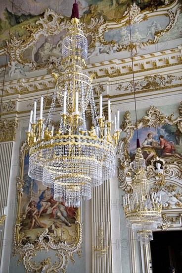 Nymphenburg Palace. Interior of Steinerner Saal the Stone or Great Hall with detail of paintings elaborate chandelier and gold and white baroque decoration by Francois de Cuvillies. Photo : Hugh Rooney