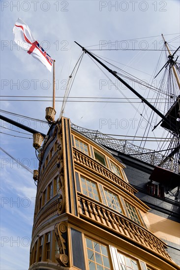 Historic Naval Dockyard HMS Victory the Flagship of Admiral Lord Nelson showing the stern with the Royal Navy White Ensign flag flying from the quarter deck. Photo : Paul Seheult