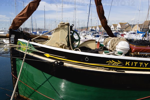 Port Solent Sailing barge SB Kitty moored in the marina with housing beyond. Photo: Paul Seheult