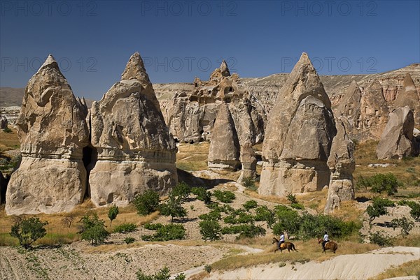 Sword Valley rock formations with horse riders in foreground. The valley got its name because of the appearance of sharpness to the pinnacles found there. Photo : Hugh Rooney