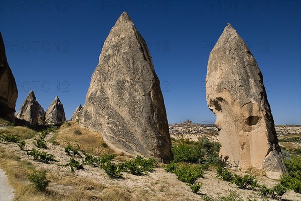 Sword Valley rock formations with hilltop town of Uchisar in distance behind. The valley got its name because of the appearance of sharpness of the rock pinnacles found there.. Photo: Hugh Rooney