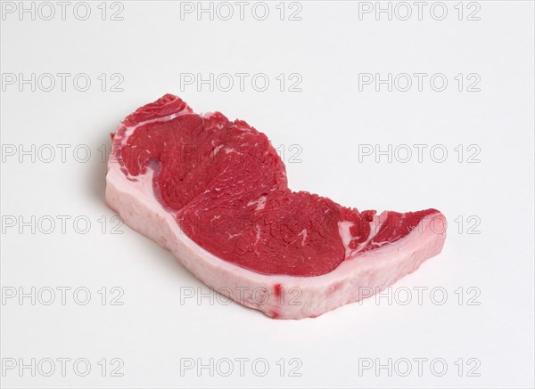 Slice of raw uncooked sirloin steak on a white background. Photo: Paul Seheult