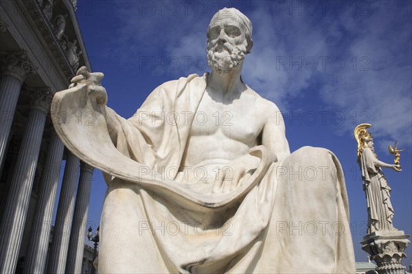 Statue of Polybius the Greek historian in front of Parliament building with statue of Athena in the background to the right. Photo : Bennett Dean