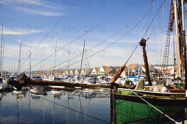 Port Solent Sailing barge SB Kitty moored in the marina with yachts and housing beyond. Photo : Paul Seheult