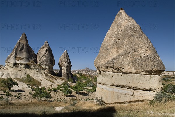 Sword Valley rock formations. The valley got its name because of the appearance of sharp pinnacles of the rock cones found there. The hilltop town of Uchisar in the distance behind. Photo : Hugh Rooney