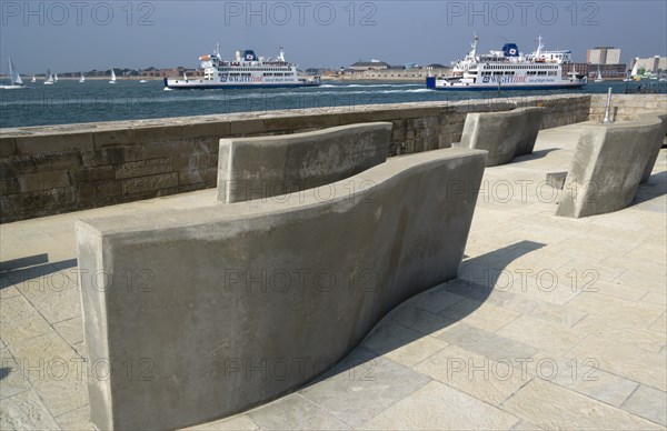 Seats on the Millenium Walk with Isle Of Wight ferries and yachts passing through the harbour entrance with HMS Dolphin beyond. Photo : Paul Seheult