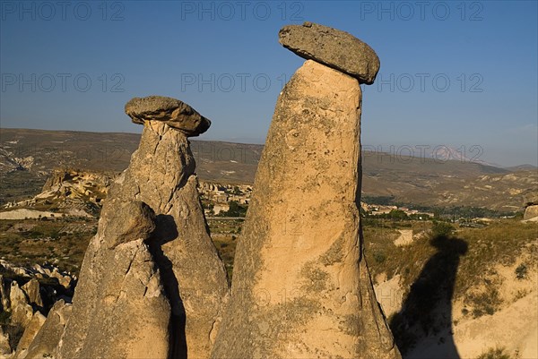 Urgup. Fairy chimney rock formations with Mount Erciyes in the background in warm golden light. Photo : Hugh Rooney