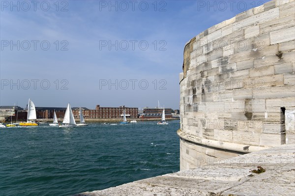 Yachts passing through the harbour entrance between HMS Dolphin in Gosport and The Round Tower in Old Portsmouth. Photo : Paul Seheult