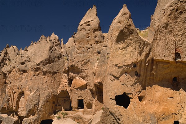 Zelve Open Air Museum. Abandoned monastic cave town inhabited until 1952 when the valley was deemed too dangerous to live in any more. Uzumlu Kilise The Church with Grapes eroded exterior cut from the rock. Photo : Hugh Rooney