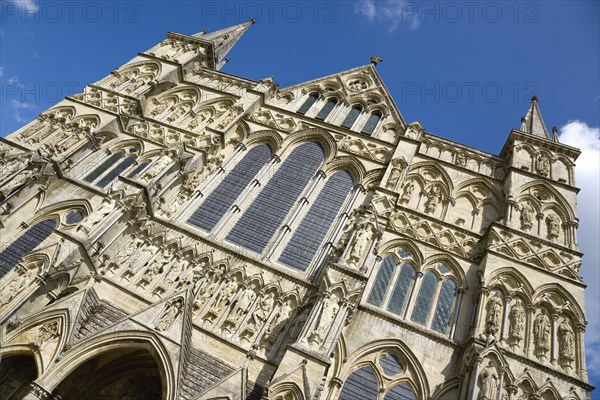 The West Front main entrance of the 13th Century Early English Gothic Cathedral Church of the Blessed Virgin Mary with the tallest spire in Britain. The statues conform to a carefully considered iconography based on the Te Deum with bishops and doctors s. Photo : Paul Seheult