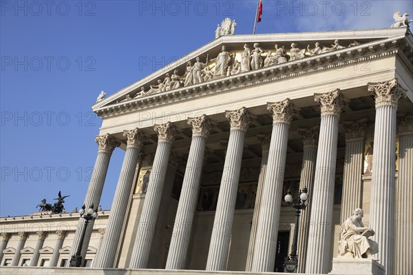 Parliament building part view of exterior facade with colonnaded entrance and carved pediment. Photo : Bennett Dean