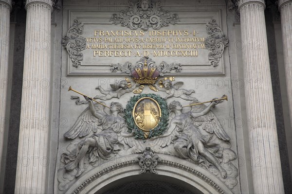 Inscription and sculpted figures above the Michaelertrakt gateway to the Hofburg Palace. Photo: Bennett Dean