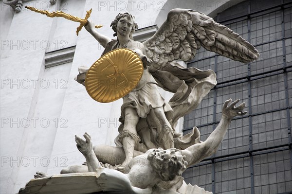 Sculpted figures above the entrance to St Michaels Church depicting St Michael slaying Lucifer by Lorenzo Mattielli. Photo : Bennett Dean