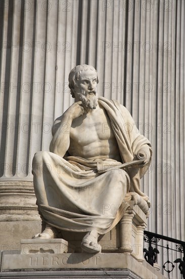 Statue of the Greek philosopher Herodotus in front of columns of the Parliament Building. Photo : Bennett Dean