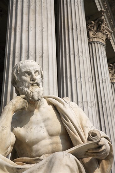 Statue of the Greek philosopher Herodotus in front of columns of the Parliament Building. Photo: Bennett Dean