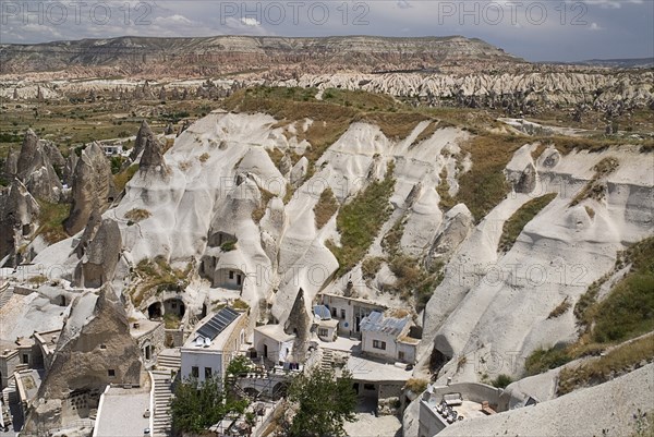 Looking down on a cave hotel built into the white tufa rock with the Red Valley behind. Photo: Hugh Rooney