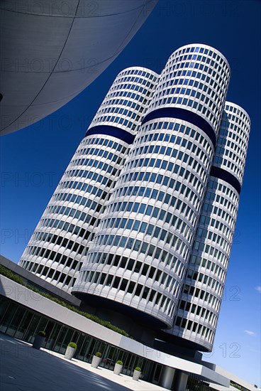 BMW Headquarters exterior. Angled view of the BMW Tower which stands 101 metres tall and mimics the shape of tyres.. Photo : Hugh Rooney