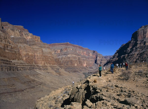 USA, Arizona, Grand Canyon, Tourists looking down onto the colorado river from within the Hualapai Indian reservation part of the canyon national park. 
Photo : Stephen Rafferty