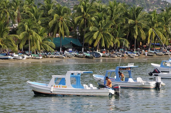 Mexico, Guerrero, Zihuatanejo, Playa Principal. Fishing boats. 
Photo : Nick Bonetti
