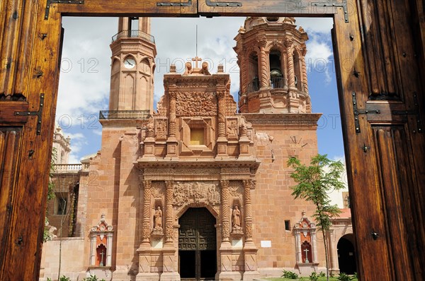 Mexico, Bajio, Zacatecas, Monastery and Church of Guadalupe seen through opening in entrance gates. 
Photo : Nick Bonetti