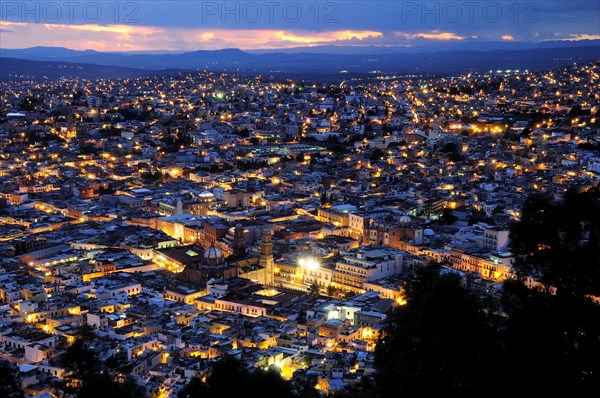 Mexico, Bajio, Zacatecas, View over city rooftops at night from Cerro de la Buffa. 
Photo : Nick Bonetti