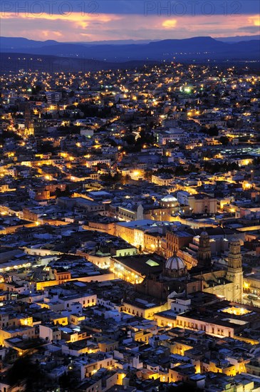 Mexico, Bajio, Zacatecas, View over city rooftops at night from Cerro de la Buffa. 
Photo : Nick Bonetti