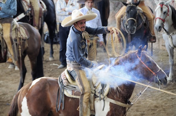 Mexico, Bajio, Zacatecas, Traditional horsemen or Charros competing in Mexican rodeo. 
Photo : Nick Bonetti