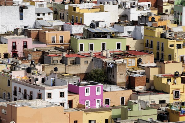 Mexico, Bajio, Zacatecas, Looking across flat rooftops of colourful houses from viewpoint at Cerro del Grillo. 
Photo : Nick Bonetti