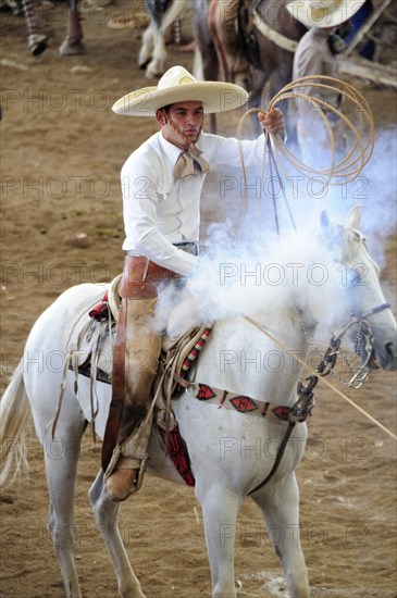 Mexico, Bajio, Zacatecas, Traditional horseman or Charro competing in Mexican rodeo holding lasso. 
Photo : Nick Bonetti
