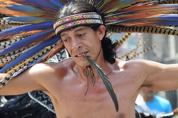 Mexico, Federal District, Mexico City, Michicoa Aztec dancer performing in the Zocalo. 
Photo : Nick Bonetti