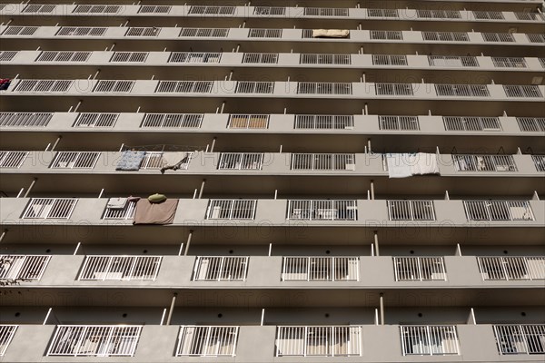 Japan, Honshu, Tokyo, Exterior or an apartment block with futon mattresses hung over balcony rails to dry. 
Photo : Jon Burbank